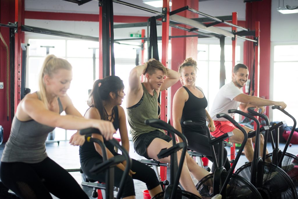 A group of cyclists engaged in an indoor cycling class